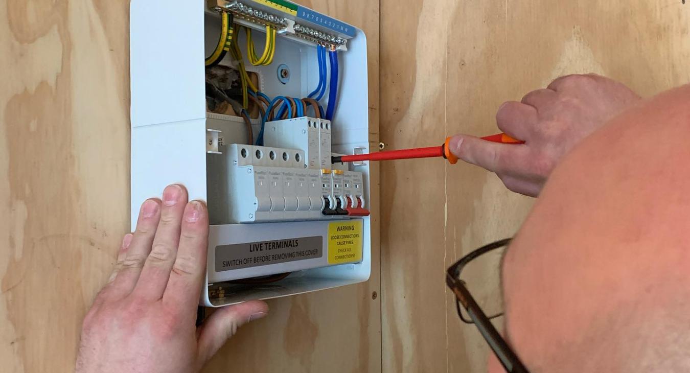 Electrician in Sawbridgeworth working on a fusebox